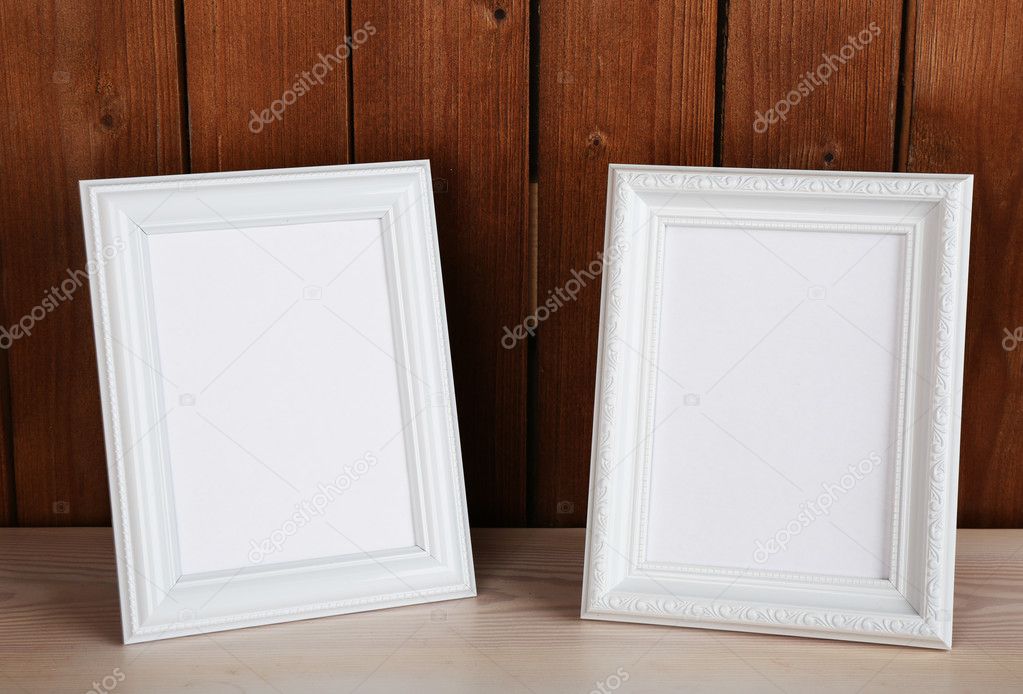 Photo frames on wooden surface