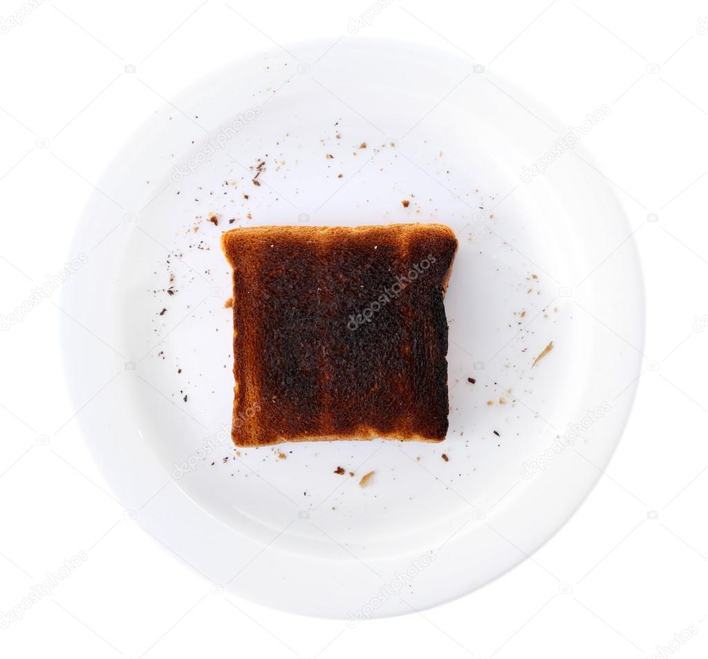 Burnt toast bread on plate, isolated on white background