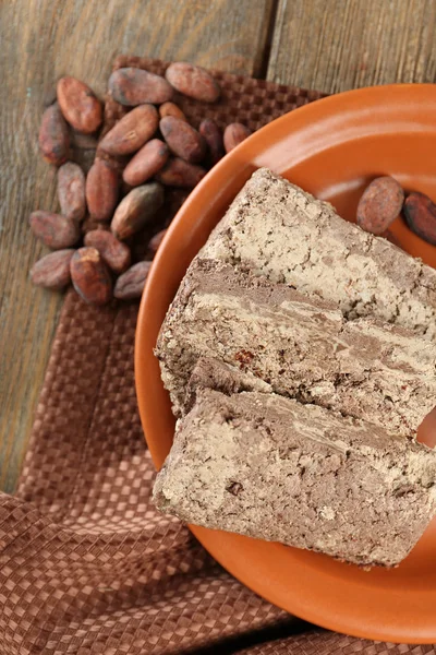 Halva de girasol con cacao en plato, sobre fondo de madera —  Fotos de Stock