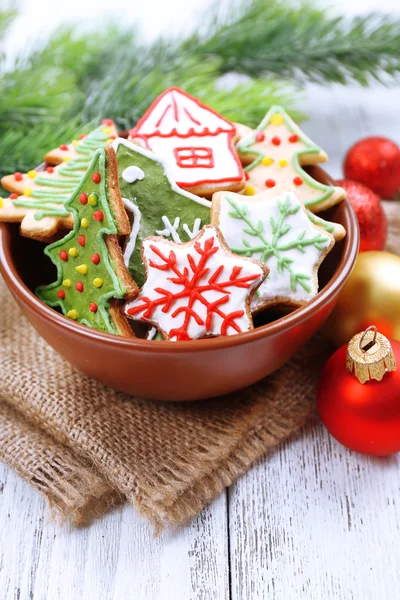 Gingerbread cookies with Christmas decoration on color wooden table background — Stock Photo, Image