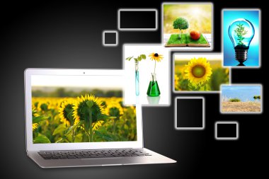 Koyu gri arka plan üzerinde laptop ve eko Tema resimleri