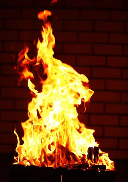 Bonfire at night on brick wall background — Stock Photo, Image