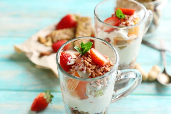 Sobremesa em camadas saudável com muesli e morangos na mesa — Fotografia de Stock