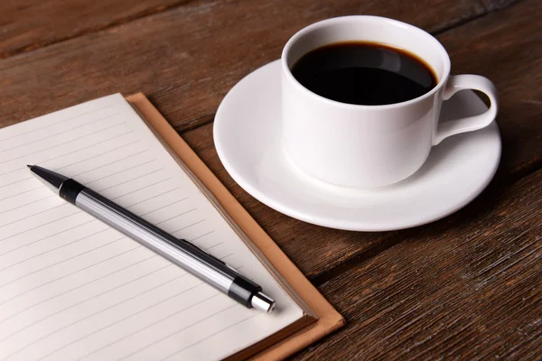 Cup of coffee with notebook — Stok fotoğraf