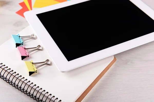 Tablet PC with office supplies on desktop background — Stock Photo, Image