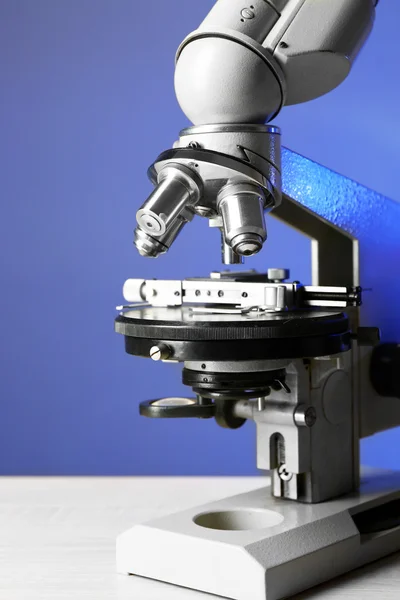 Microscope on blue background, close-up — Stock Photo, Image