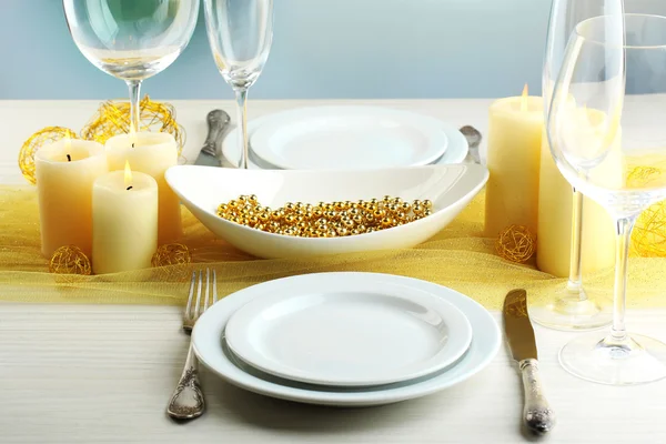 Beautiful holiday table setting in white and gold color