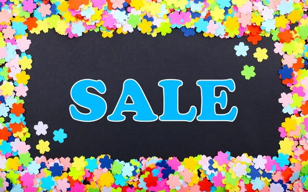 Sale word on black background in confetti frame — Stock Photo, Image