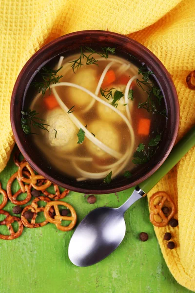 Soup with meatballs and noodles in bowl on wooden background — Stock Photo, Image