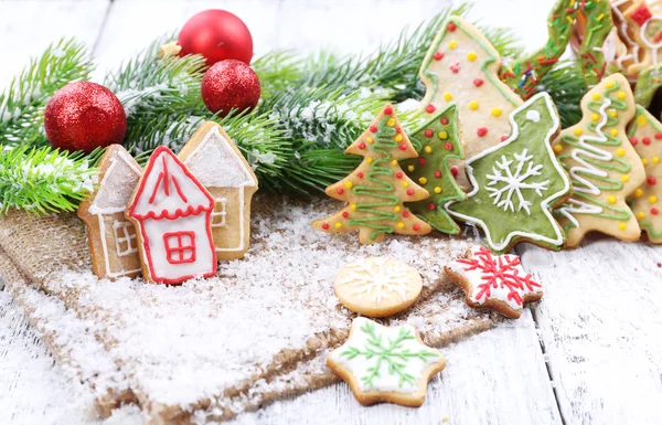 Gingerbread cookies with Christmas decoration on color wooden table background — Stock Photo, Image