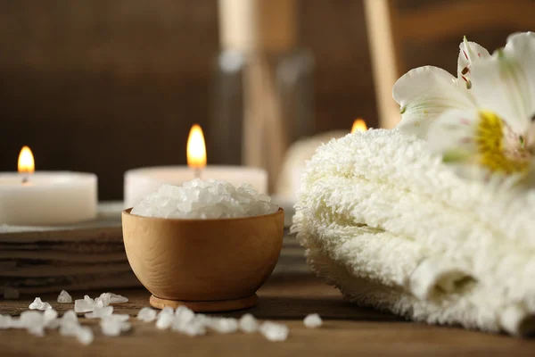 Composition of spa treatment, candles in bowl with water on wooden background — Stock Photo, Image