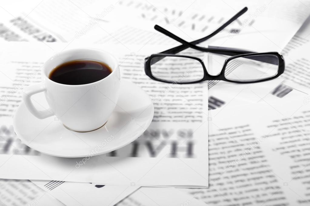 Glasses and newspapers, close-up