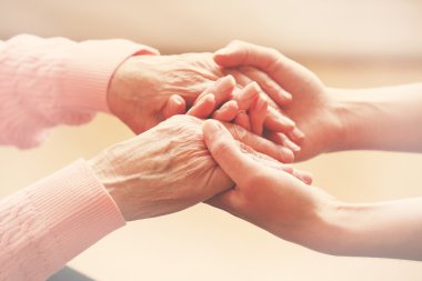 Helping hands, care for the elderly concept clipart