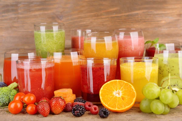 Copos de suco fresco saboroso, na mesa de madeira . — Fotografia de Stock