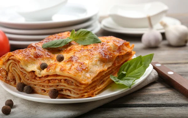 Portion of tasty lasagna on wooden table — Stock Photo, Image