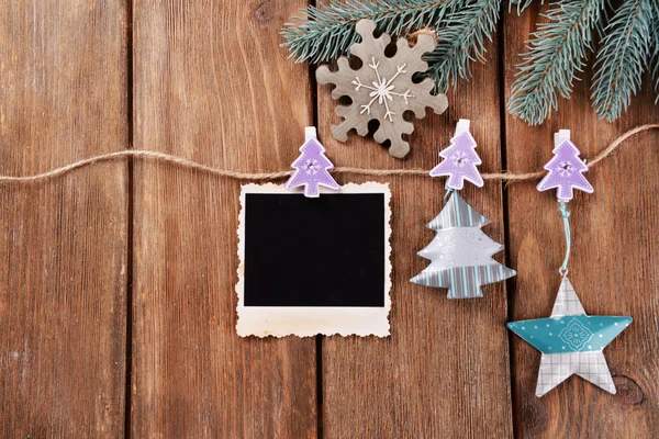 Blank photo frames and Christmas decor with snow fir tree on wooden background — Stock Photo, Image