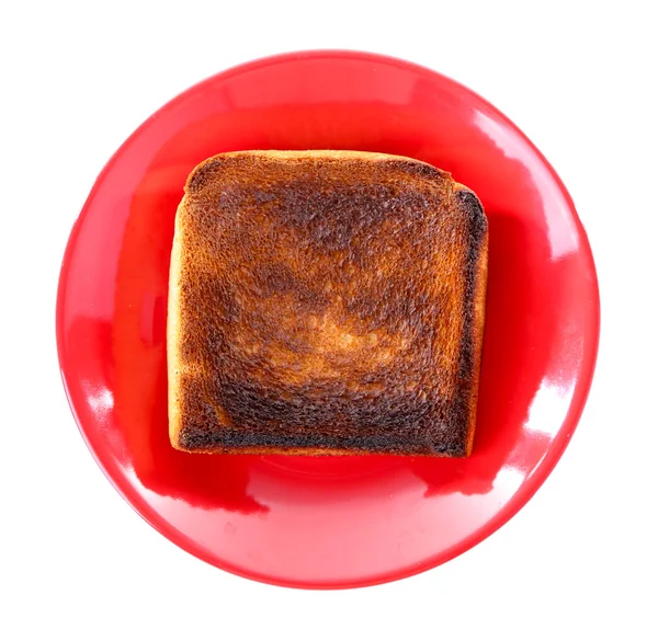 Verbrande toast brood op plaat, geïsoleerd op witte achtergrond — Stockfoto