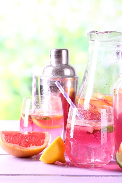 Růžové limonády ve skle a džbán na tabulka detail — Stock fotografie