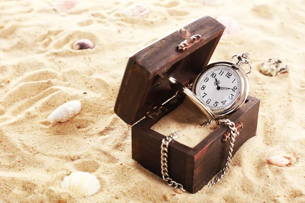 Silver pocket clock on sand background — Stock Photo, Image