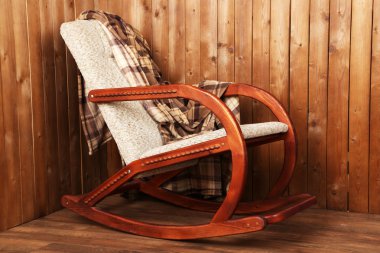 Sallanan sandalye ahşap duvar arka plan üzerinde ekose kaplı