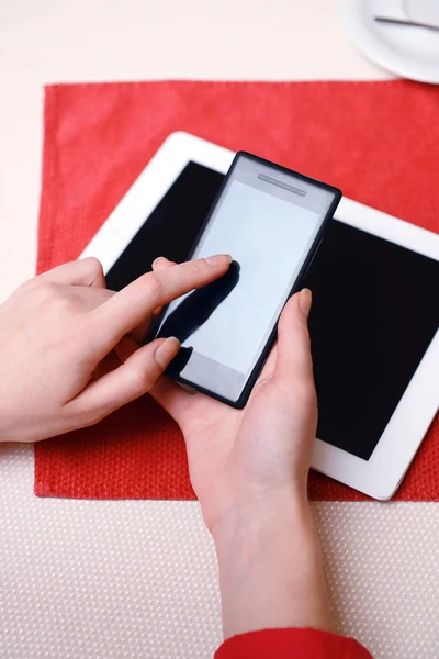 Woman with mobile phone and tablet computer in cafe shop — Stock Photo, Image