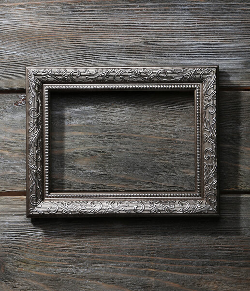 Vintage photo frame on wooden background