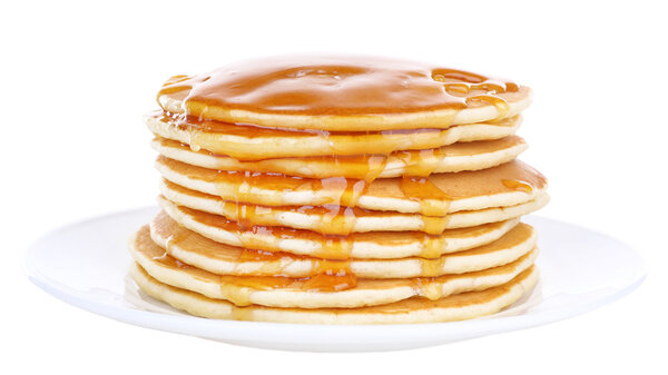 Stack of delicious pancakes with honey on plate isolated on white