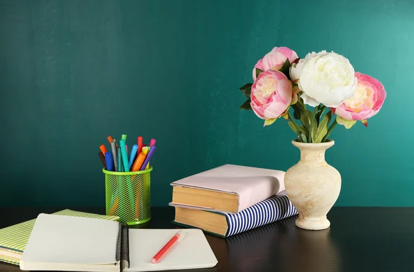Desk with books and flowers