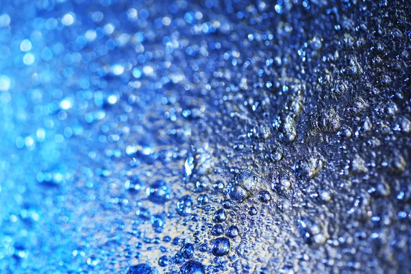 Water drops on color surface background, macro view — Stock Photo, Image