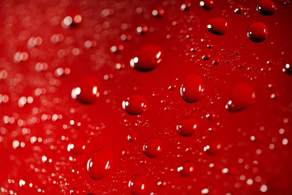 Water drops on color surface background, macro view — Stock Photo, Image