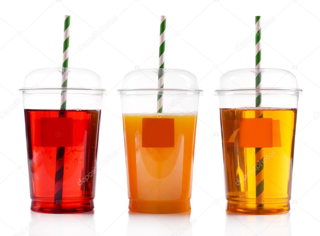 Fruit juices in fast food closed cups with tubes isolated on white