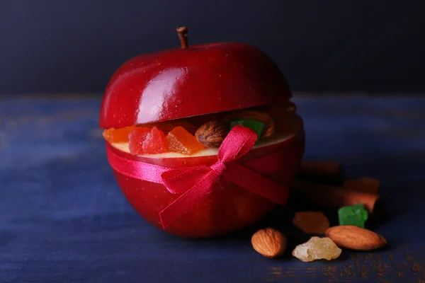 Red apple stuffed with dried fruits — Stock Photo, Image