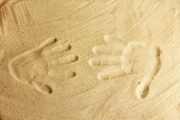 Hand prints in sand as nice summer background — Stock Photo, Image