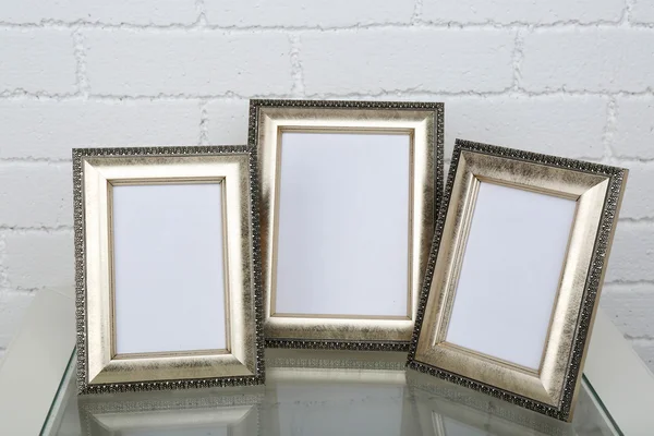 Photo frames on coffee table — Stock Photo, Image