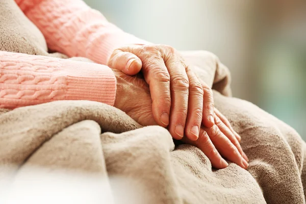 Hands of adult woman on light background, closeup — Stock Photo, Image