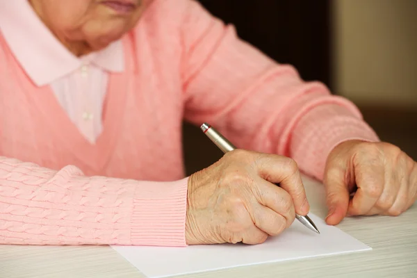 Handen van volwassen vrouw schrijven met pen — Stockfoto