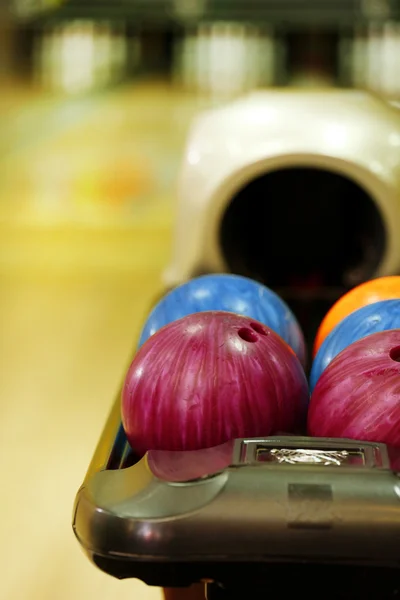 Colorful Bowling balls in ball return — Stock Photo, Image