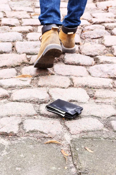 Ztratil koženou peněženku a pěší mužské nohy, venku — Stock fotografie