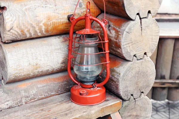 Kerosene lamp on wooden hose background — Stock Photo, Image