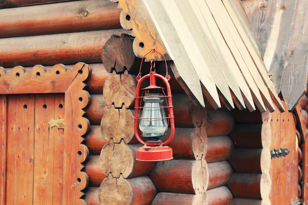 Kerosene lamp hanging on wooden house, outdoors — Stock Photo, Image
