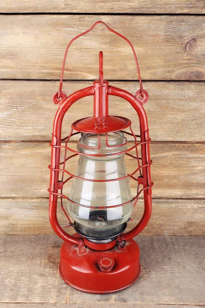 Kerosene lamp on wooden planks background — Stock Photo, Image