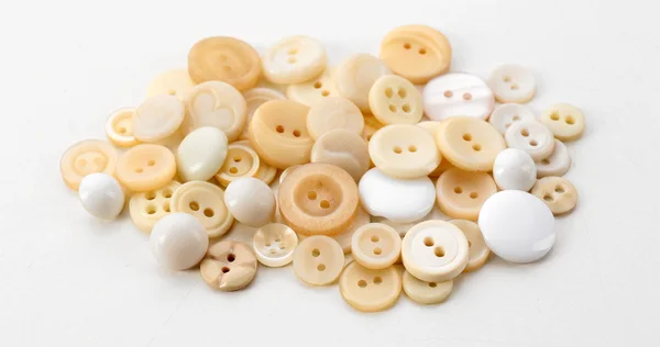 Beige sewing buttons isolated on white — Stock Photo, Image