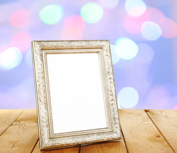 Photo frame on wooden table — Stock Photo, Image