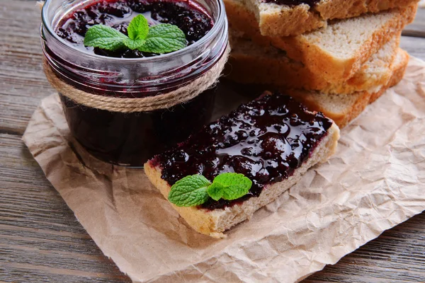 Delicious black currant jam on table close-up — Stock Photo, Image