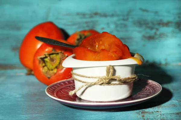 Ripe sweet persimmons, on wooden table — Stock Photo, Image