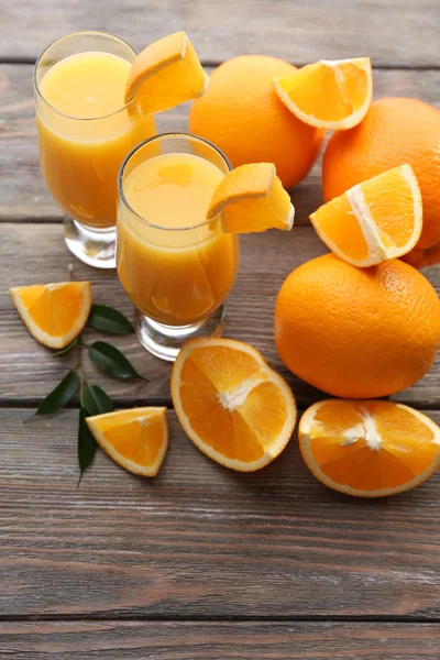 Freshly squeezed orange juice on wooden table — Stock Photo, Image