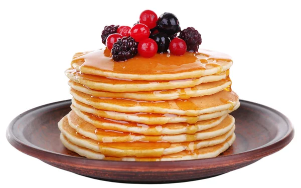 Stack of delicious pancakes with berries and honey isolated on white — Stock Photo, Image