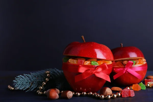 Červená jablka plněná sušené ovoce na dřevěný stůl barvy a tmavým pozadím — Stock fotografie