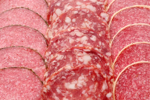 Slices of salami, macro view — Stock Photo, Image