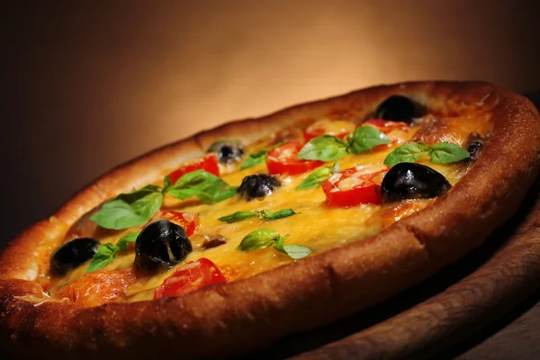 Italian pizza on wooden board dark colorful background — Stock Photo, Image